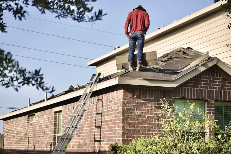 Professional roofer working on a residential roof in Biltmore